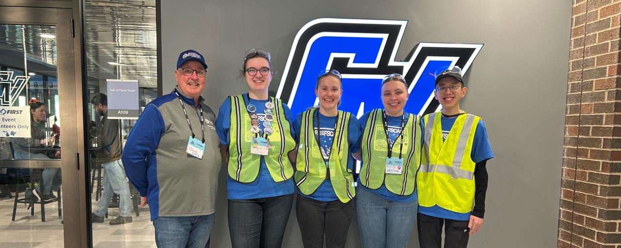 Dr. Huizen with the 2025 FIRST Robotics Safety Team in front of the GV Athletic logo
